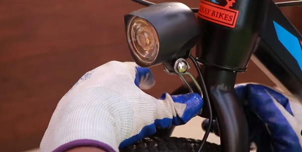 Light and horn being attached to the front suspension of a bicycle